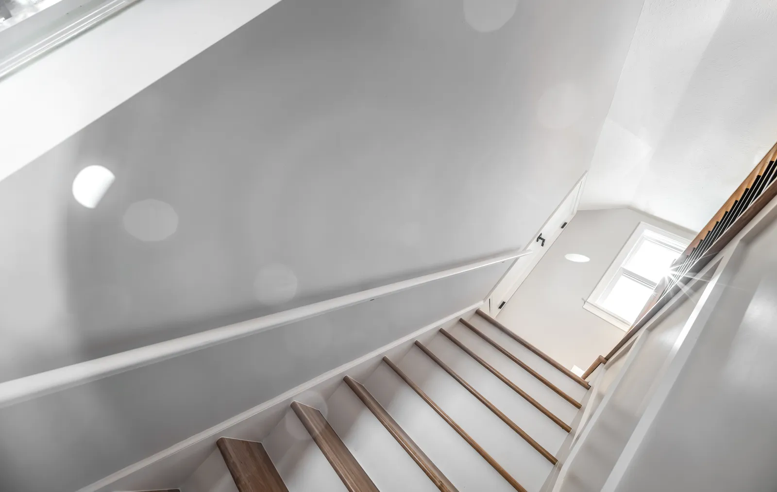 Staircase looking down with oak treads and handrail